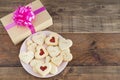 Dish with heart-shaped cookies on a wooden base. Concept Valentine`s Day, Mother`s Day, anniversary