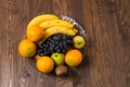 In dish are heathful bananas, oranges, grapes and apples Royalty Free Stock Photo