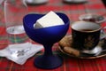 Dish with jam, cup with coffee and cookies, blue cup with ice cream, glass with water, teaspoon