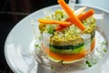 a dish with layered vegetable terrine and clear gel strips