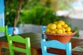 A dish of lemons in typical greek outdoor cafe