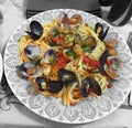 Dish of linguine with mussels and clams with tomato sauce and pa