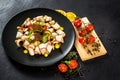 Dish of many pieces of lard with vegetables on black background Royalty Free Stock Photo