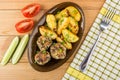 Dish with meatballs, baked potatoes, pieces of tomatoes and cucumbers Royalty Free Stock Photo