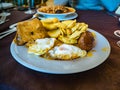 Typical meal from Malaga, Spain. ItÃÂ´s a combination plate fried potatoes, fried eggs, chorizo,black