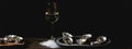 Dish of oysters with lemon slices ice cubes and white wine serving dark background. Close-up. Generative Ai content.