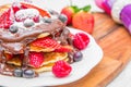 Dish with pancakes and strawberry,raspberry and blueberry and chocolate