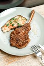 dish plate with meat steak on the bone in the restaurant Royalty Free Stock Photo