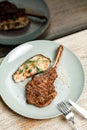 dish plate with meat steak on the bone in the restaurant Royalty Free Stock Photo
