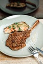 dish plate with meat steak on the bone in the restaurant Royalty Free Stock Photo
