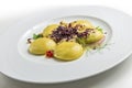 Dish of potato ravioli with crustacean ragout and berries