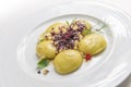 Dish of potato ravioli with crustacean ragout and berries