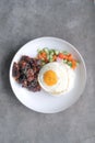 A Dish of Rice Bowl with Chicken mixed with Black Pepper Sauce.