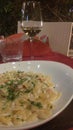 Dish salmon italian pasta with white wine glass Royalty Free Stock Photo