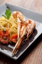 Dish with scampi spaghetti and tomatoes