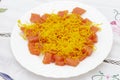 Dish of smoked salmon pieces decorated with angel hair