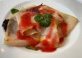 Dish of smoked swordfish carpaccio appetizer in strawberry sauce. Italian cuisine