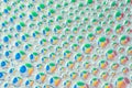 Dish soap water bubbles on blue, yellow, green red pastel circles