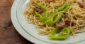 A dish of spaghetti on wooden table Royalty Free Stock Photo