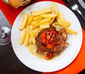 Dish of Spanish cuisine - pork cheeks with potatoes fri and stew vegetables