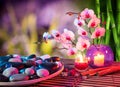 Dish of stones massage with orchids and bamboo Royalty Free Stock Photo