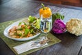 Dish of Thai style salad with cutlery, glass of water Royalty Free Stock Photo