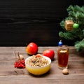 Dish of traditional Slavic treat on Christmas Eve. Christmas tree, apples, walnuts, glass of compote, viburnum. Brown and Royalty Free Stock Photo