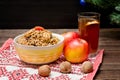 Dish of traditional Slavic treat on Christmas Eve. Christmas tree, apples, walnuts, glass of compote on a patterned tablecloth. B Royalty Free Stock Photo