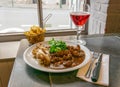 A dish of veal kidneys with juniper berries and juniper vodka enever. Also fries and ruby beer. A traditional Belgian dish