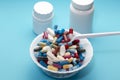 Dishes colorful pills on a plate and two bottle Royalty Free Stock Photo