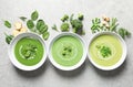 Dishes with different fresh vegetable detox soups made of green peas, broccoli, spinach and ingredients on table