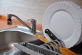 Dishes in drip tray. Clean washed dishes in the kitchen Royalty Free Stock Photo