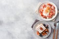 Dishes for home cooked hearty Breakfast. Fried eggs with sausages and tomatoes. Belgian fluted waffles with figs and grapes. Gray Royalty Free Stock Photo