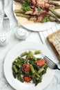 Dishes with oven baked asparagus served on white marble table, flat lay Royalty Free Stock Photo