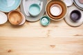 Dishes for serving and eating meals on a wooden background, space for text, top view. Modern ceramic and wooden crockery, trendy Royalty Free Stock Photo