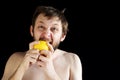 Dishevelled man eating a lemon Royalty Free Stock Photo