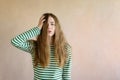 Dishevelled woman in a striped vest