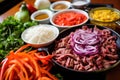 dishing up colorful pepper strips, onions, and beef fajita