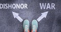 Dishonor and war as different choices in life - pictured as words Dishonor, war on a road to symbolize making decision and picking Royalty Free Stock Photo