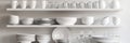 Dishware set in white shelving unit, tableware shelf, kitchen interior, clean white mugs, plates, glass tableware Royalty Free Stock Photo