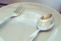 Dishware set on wood table with plate, spoon and fork Royalty Free Stock Photo