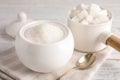 Dishware with sugar on white table