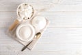 Dishware with sugar on white wooden table. Space for text