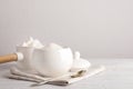 Dishware with sugar on white wooden table. Space for text