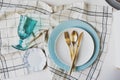 Dishware winter set in blue and white tones with gold cutlery on white background. Royalty Free Stock Photo