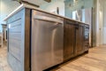 Dishwasher cabinets and drawers under the white countertop of a kitchen island