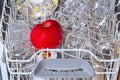 Dishwasher with clean dishes and apple Royalty Free Stock Photo