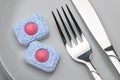 Dishwasher detergent tablet, fork and knife Royalty Free Stock Photo