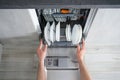 Dishwasher flat lay. A man unloads a dishwasher, the hands of a man