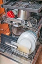 Dishwasher in kitchen and dirty dishes inside Royalty Free Stock Photo